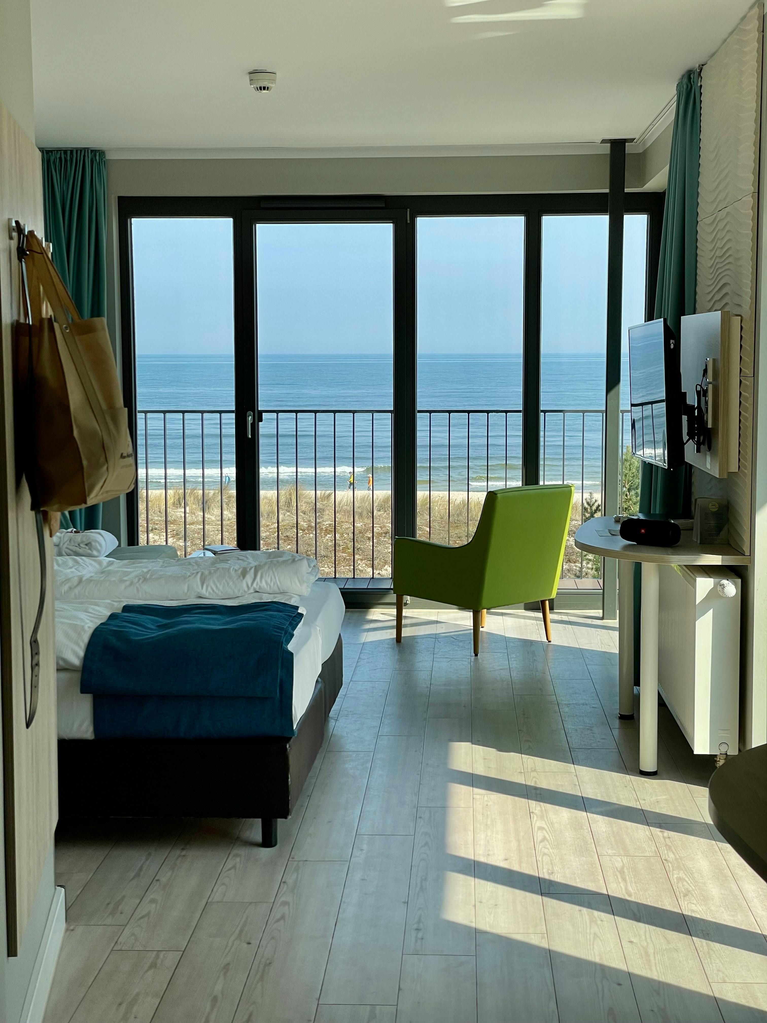 Stylish hotel room with ocean view in Heringsdorf, featuring modern interior design.